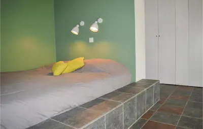 a bed in a room with green walls at Cozy Home In San Giuliano With Wifi in San-Giuliano