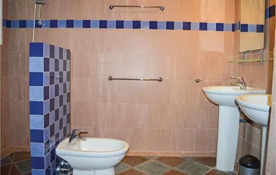 a bathroom with two sinks and two toilets at Cozy Home In San Giuliano With Wifi in San-Giuliano