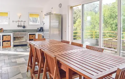 a kitchen with a large wooden table and chairs at Cozy Home In San Giuliano With Wifi in San-Giuliano