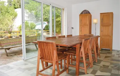 a dining room with a wooden table and chairs at Cozy Home In San Giuliano With Wifi in San-Giuliano