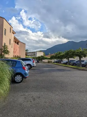 a parking lot with cars parked on the street at Vue sur mer cala Di sognu in San-Nicolao