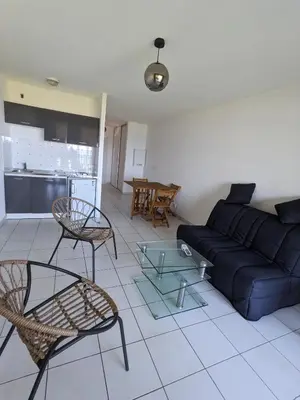 a living room with a blue couch and chairs at Vue sur mer cala Di sognu in San-Nicolao