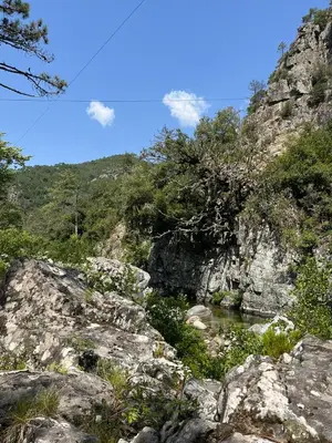a view of a mountain with a river and rocks at Duplex vue mer à Piana Verde Canale-di-verde in Canale-di-Verde