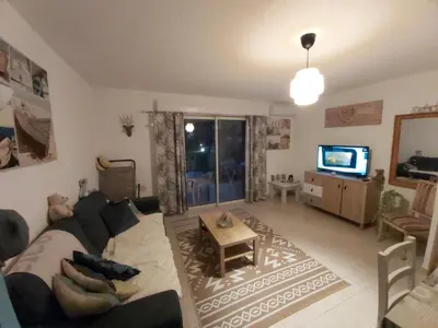 a living room with a couch and a tv at Ville melody in San-Nicolao