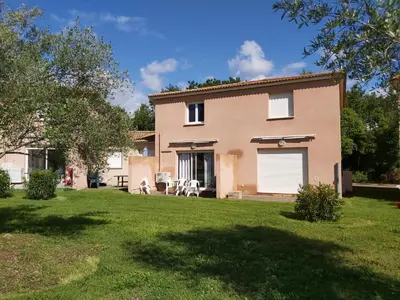 a large house with a garage and a yard at Ville melody in San-Nicolao
