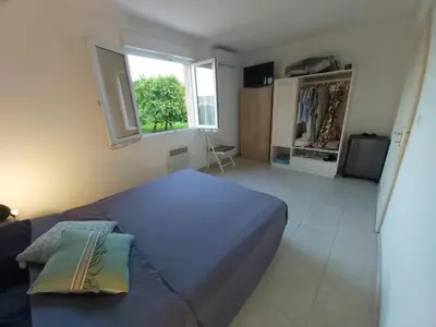 a bedroom with a blue bed and a window at Ville melody in San-Nicolao
