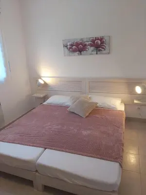 a bed in a bedroom with a picture on the wall at Ville melody in San-Nicolao
