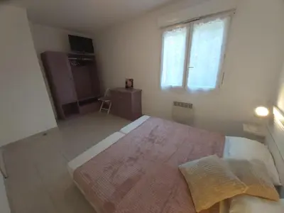 a bedroom with a large bed and a window at Ville melody in San-Nicolao