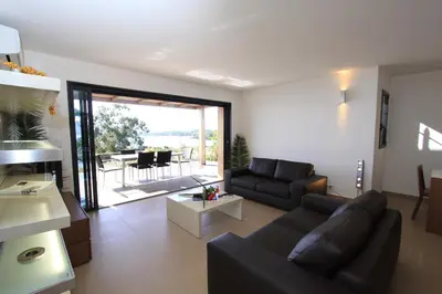 a living room with a couch and a table at Résidence Affasciata in Porto-Vecchio