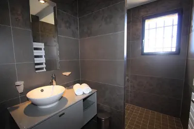 a bathroom with a sink and a mirror at Résidence Affasciata in Porto-Vecchio
