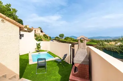 a view from the balcony of a villa with a swimming pool at L'Ornano - Maison climatisée avec piscine in Grosseto-Prugna