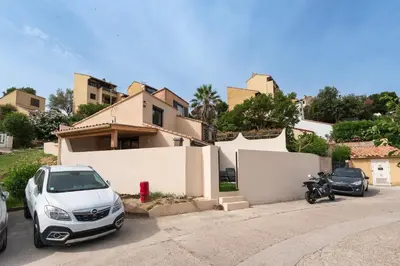 a car and a motorcycle parked in front of a house at L'Ornano - Maison climatisée avec piscine in Grosseto-Prugna