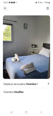 a bedroom with a bed with two towels on it at Rez de villa avec jardin in Porto-Vecchio