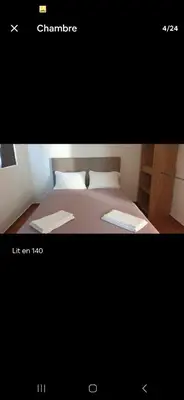 a picture of a bedroom with a bed in a room at Rez de villa avec jardin in Porto-Vecchio