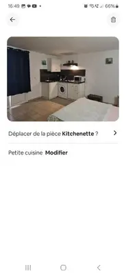 a room with a bed and a kitchen at Rez de villa avec jardin in Porto-Vecchio