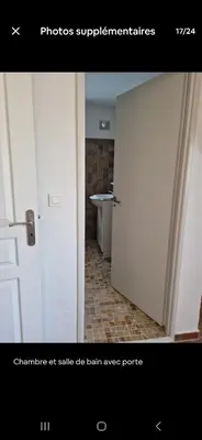 an open door to a bathroom with a sink at Rez de villa avec jardin in Porto-Vecchio