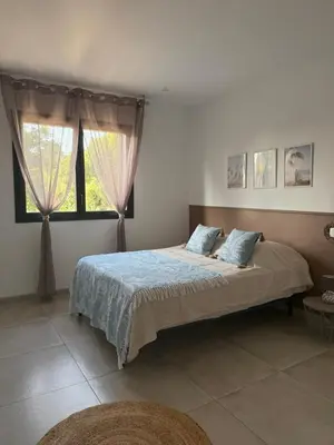 a flat screen tv on a white wall with pictures at Casa l'Alivetu in Vescovato