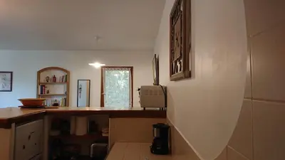 a kitchen with a counter and a window at T2 400m plages et commerces excellent rapport qualité prix! in Propriano
