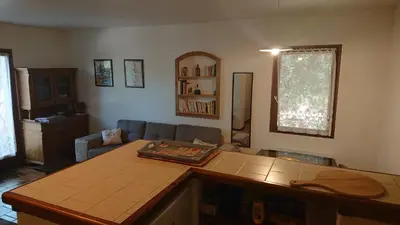 a living room with a couch and a table at T2 400m plages et commerces excellent rapport qualité prix! in Propriano