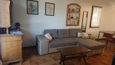 a living room with a couch and a table at T2 400m plages et commerces excellent rapport qualité prix! in Propriano