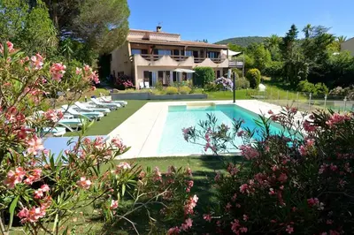 a house with a swimming pool in front of a house at Corsicadream cupabia, appartement dans villa proche Porticcio, vue mer, piscine in Pietrosella