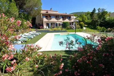 a house with a swimming pool in front of a house at Corsicadream cupabia, appartement dans villa proche Porticcio, vue mer, piscine in Pietrosella