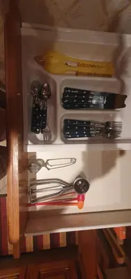 a drawer filled with utensils on a shelf at Appt cosy rez de villa in Furiani