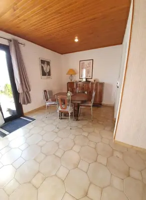 a dining room with a table and chairs at Appt cosy rez de villa in Furiani