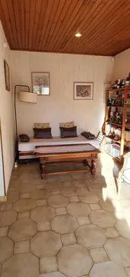 a bed in a room with a wooden ceiling at Appt cosy rez de villa in Furiani