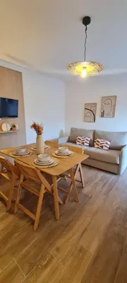 a living room with a table and a couch at Limiria Studio in Santa-Maria-Poggio