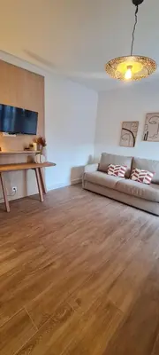 a living room with a couch and a table at Limiria Studio in Santa-Maria-Poggio