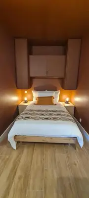 a bedroom with a large bed with two night stands at Limiria Studio in Santa-Maria-Poggio