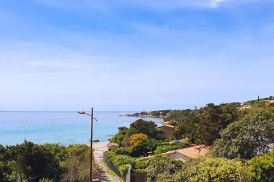 a view of the ocean from a hill with a street light at Villa U Rustincu Vue mer Acces plage Ruppione Pietrosella in Pietrosella