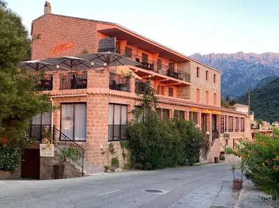 a large brick building with balconies on a street at Appartement Porto - Ota in Porto Ota