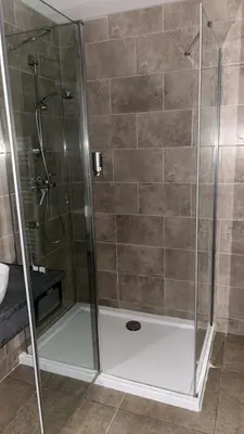a shower with a glass door in a bathroom at Appartement Porto - Ota in Porto Ota