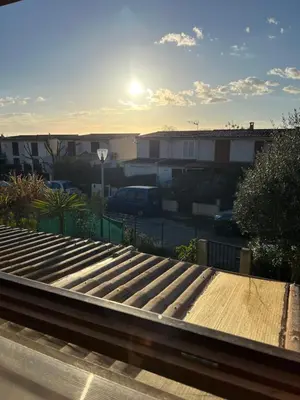 a view of the sun setting over a parking lot at Pavillon chez Michel corse in Poggio-Mezzana