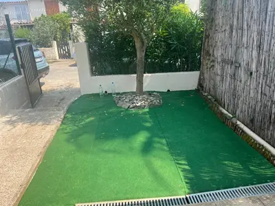 a green lawn with a tree on top of it at Pavillon chez Michel corse in Poggio-Mezzana