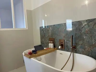 a bathroom with a tub with a laptop on it at T2 ville et bord de mer in Ajaccio