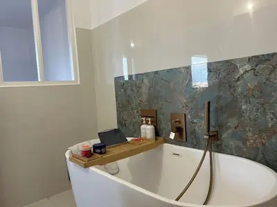 a bathroom with a bath tub with a laptop on it at T2 ville et bord de mer in Ajaccio