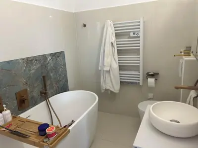 a bathroom with a tub and a toilet and a sink at T2 ville et bord de mer in Ajaccio