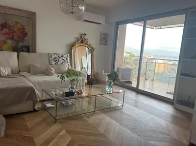 a living room with a couch and a glass table at T2 ville et bord de mer in Ajaccio