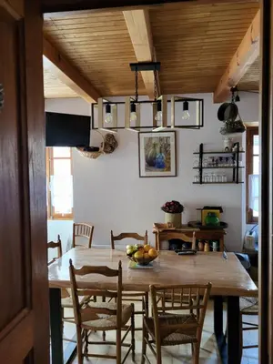 a dining room with a large wooden table and chairs at Maison de village in Silvareccio