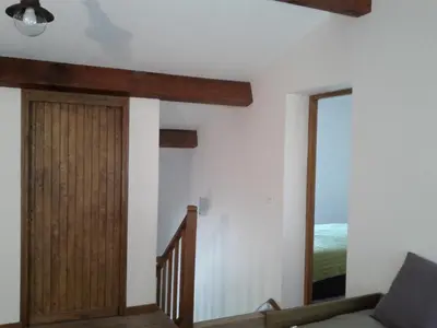 a room with a wooden door and a stairway at Villa vue mer 400m plages et commerces calme confort pour 6 à 8 personnes soins de remise en forme possible in Propriano