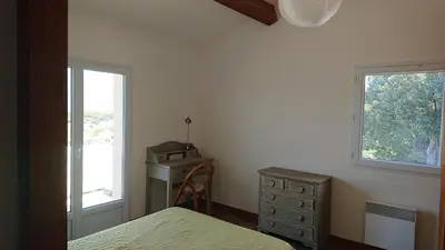 a bedroom with a bed and a dresser and a window at Villa vue mer 400m plages et commerces calme confort pour 6 à 8 personnes soins de remise en forme possible in Propriano