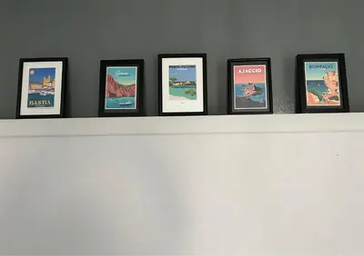 a shelf with a bunch of pictures on it at Jardin-Marin-Ajaccio in Ajaccio