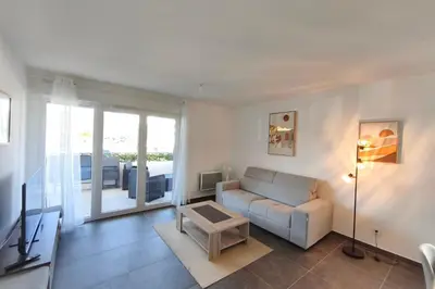 a living room with a couch and a table at T2 apartment with terrace in Ajaccio