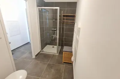 a bathroom with a shower with a glass door at T2 apartment with terrace in Ajaccio