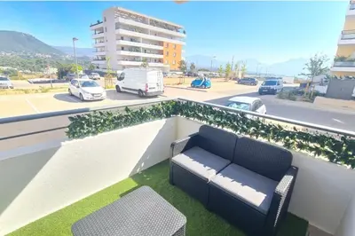 two chairs and a table on a balcony at T2 apartment with terrace in Ajaccio