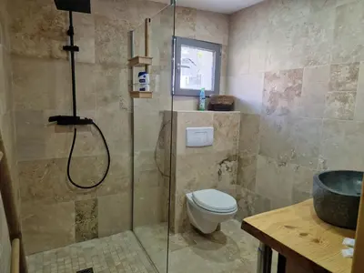 a bathroom with a shower and a toilet at Agréable studio in Afa