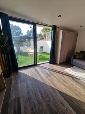 a living room with a large sliding glass door at Agréable studio in Afa